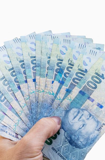 South African banknotes in hand. South African banknotes in hand.